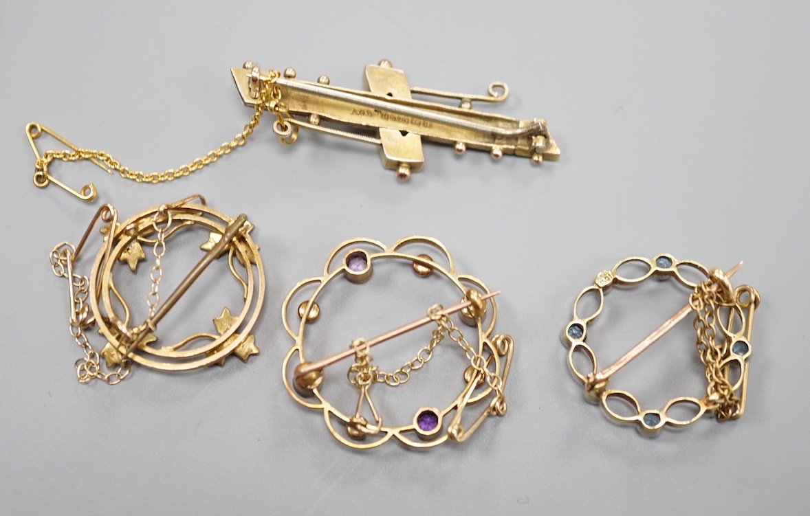 A late Victorian 9ct gold and gem set bar brooch, 43mm and a 9ct and seed pearl set open work brooch, gross 6 grams, a yellow metal amethyst and seed pearl brooch, gross 4 grams and a 15ct, aquamarine and seed pearl set